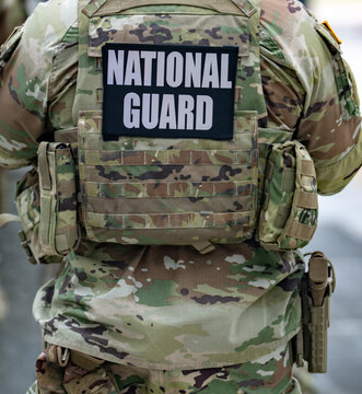 Washington DC. USA. National Guard. Military group in uniform. Military patrol on street. Military gear and body armor. Military presence in city.