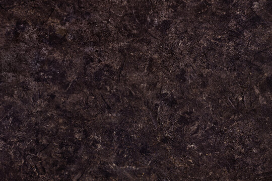 Abstract brown plastered textured grunge background in the form of a rough covered stucco wall, closeup