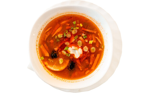 Top view of rich solyanka soup with sour cream.