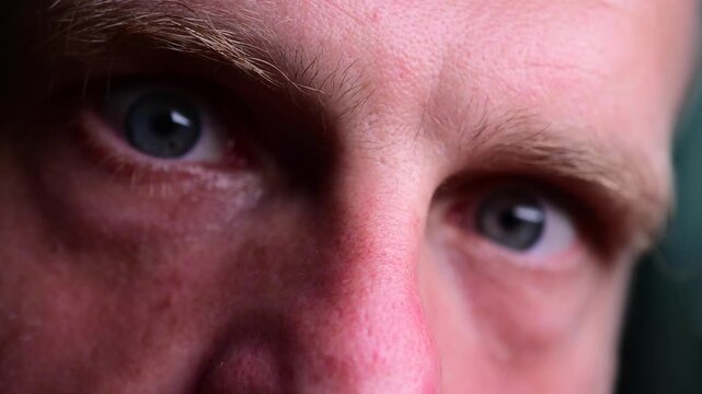 Macro close up cinematic off focus bokeh video, abstract artistic, emotion, human body, vivid men blue eye's 