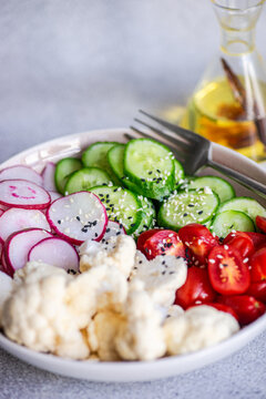 Fresh salad with radish, cucumber, and cauliflower