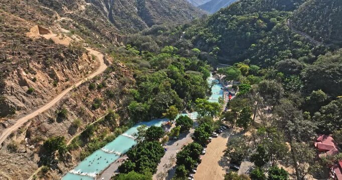 Tolantongo Mexico Aerial v8 birds eye view drone fly around hot springs resort and famous remote box canyon, tilt up reveals beautiful mountain ranges - Shot with Mavic 3 Cine - December 2021