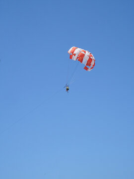 Colorful Parasail Flying Against Clear Blue Sky