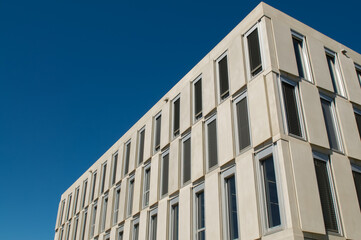Obraz premium Modern university campus est building facade under a blue sky in Lugano