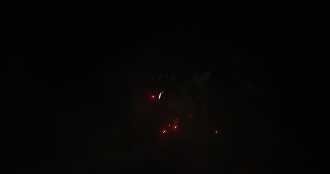 Glowing Fireworks Bursting In Night Sky And Leaving Smoke - Low Shot