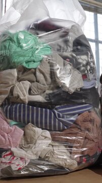 Bales filled with used kids clothing and shoes prepared for donation. Concept of charity, helping children and community support
