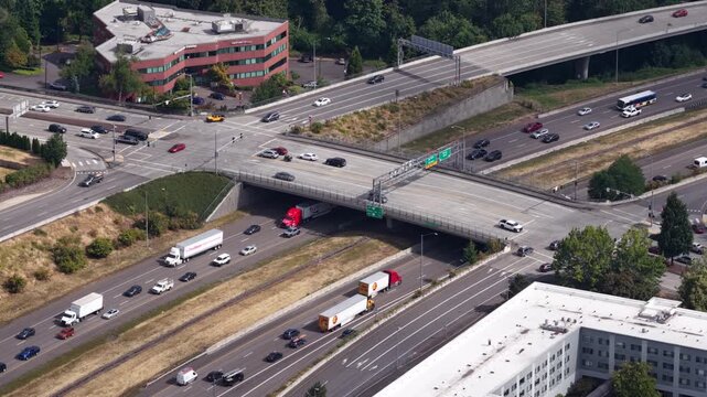 Aerial of Highway 205 interchange and commercial area near Happy Valley Oregon with multilane highway overpasses and stop and go traffic in southeast Portland in summer