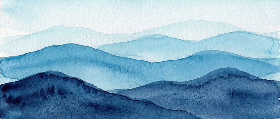 Fototapeta premium An artistic watercolor landscape background featuring light and dark shades of blue and layered, undulating hills.