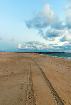 Incredible sunset over a wide ocean beach, on the background of a colourful, cloudy sky