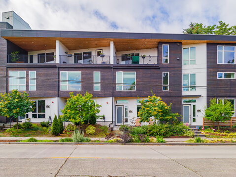 Modern multi-unit residential building with wooden facade and balconies