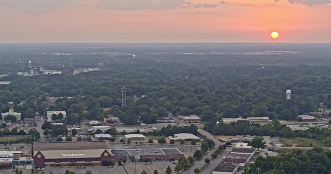 Tupelo Mississippi Aerial v6 tilting shot of hazy glowing orange sunset, city townscape and vast expanse of countryside landscape - Shot with Inspire 2, X7 camera - August 2020