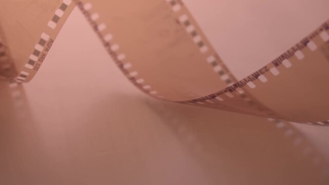  35mm negative photographic film in rotation .Slightly rolled film strip Analog film strips. Analog photography. Close-up. 