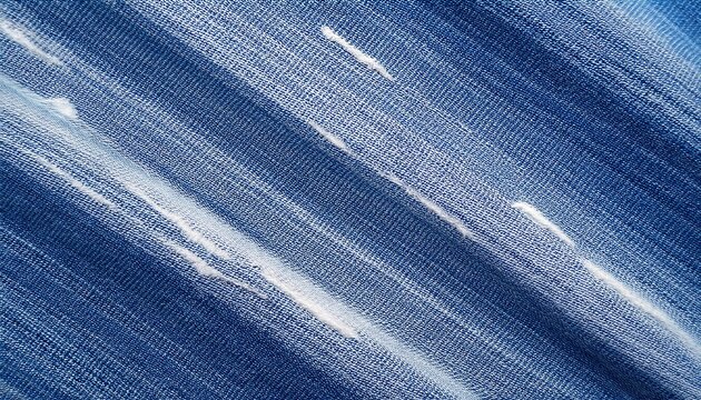overhead view distressed denim texture background direct top down perspective diagonal twill weave in blue and white tones striped fabric pattern with irregular frayed worn patches and loose pale t