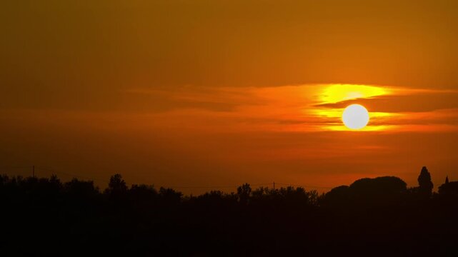 Time- Lapse of beautiful and colorful sunset at Tuscany. This time-lapse captures the fleeting magic of twilight over the rolling hills of Italy.