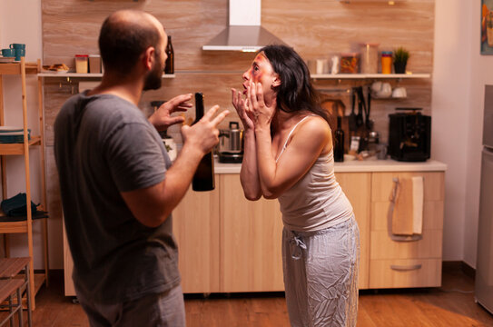 Violent husband attacking wife at home portrays domestic violence, emotional trauma and personal safety in an unsafe home relationship.