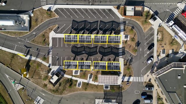 Saulce-sur-Rhone, France - June 26, 2026: Aerial drone view of Fastned electric vehicle charging station with solar canopies along the A7 motorway in Southern France, showcasing modern EV fast chargin