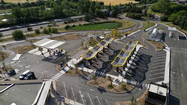 Saulce-sur-Rhone, France - June 26, 2026: Aerial drone view of Fastned electric vehicle charging station with solar canopies along the A7 motorway in Southern France, showcasing modern EV fast chargin