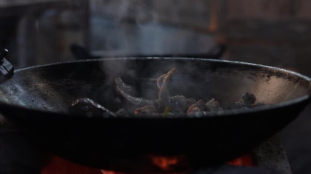 Authentic Thai hill tribe home kitchen where traditional local food is being prepared using simple cooking methods and fresh natural ingredients. This rustic scene highlights indigenous culinary tradi