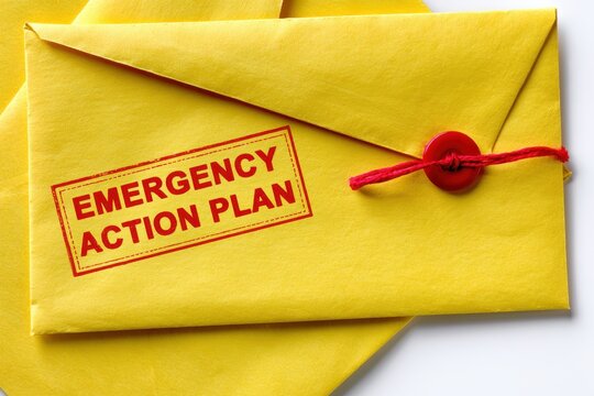 Emergency action plan stamp on yellow envelope. Safety concept.