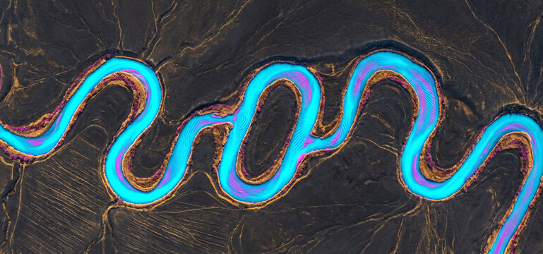 Aerial view of a winding blue river flowing through a dark textured landscape in a serene style