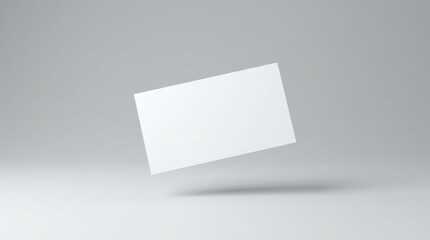 Naklejka premium Blank white card floats in air with shadow on gray background