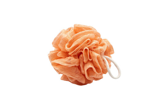 A single peach colored mesh bath sponge with a white elastic loop isolated on a solid black background, soft texture for body scrubbing