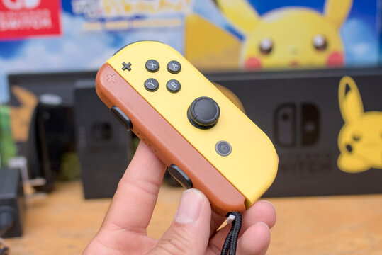Close up of a Nintendo Switch Pikachu and Eevee Edition Joy Con controller, nintendo controller concept