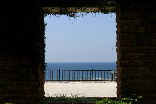 Beautiful ocean view through a stone wall window frame in Okinawa