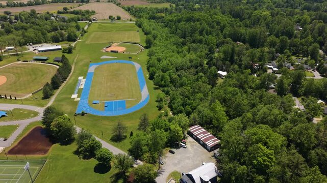 Aerial perspective captures sports fields and community structures in Brevard, North Carolina, highlighting lush greenery and organized outdoor areas