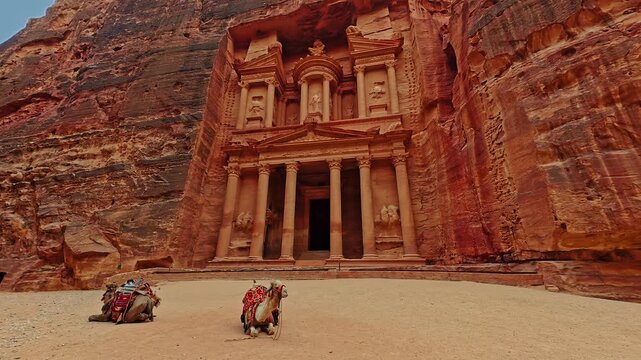 Ancient Treasury Al Khazneh Carved in Rock at Petra Jordan with Bedouin Camels