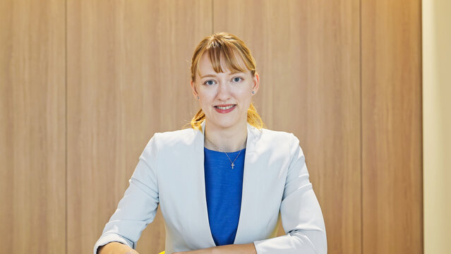 A Caucasian woman speaking during a video conference.