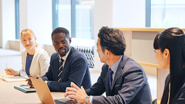 A group of multinational businesspeople having a meeting in a conference room.