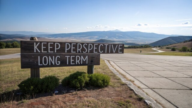 Inspiring Wooden Sign with Motivational Message on Scenic Hilltop Overlooking Expansive Landscape and Blue Sky