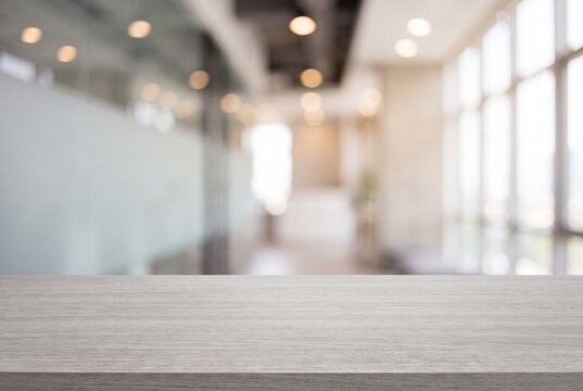 Empty wooden table top with blurred office interior background