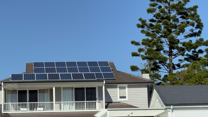 Fototapeta premium Modern Residential House with Solar Panels on Tiled Roof