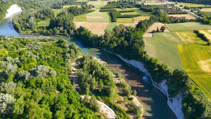 Obraz premium Aerial View of Tanaro River Winding Through Piedmont Farmland and Forests