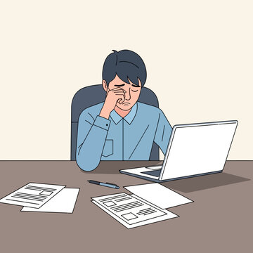 Stressed Businessman Rubbing Eyes Working Late On Laptop