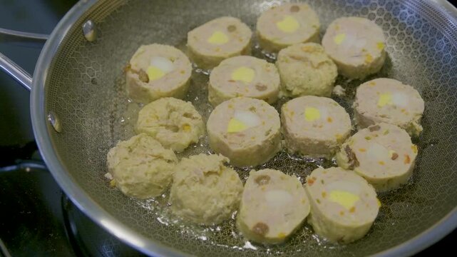 Filipino embutido cooking process with ground meat, eggs, and vegetables in a pan