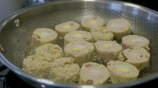 Filipino embutido cooking process with ground meat, eggs, and vegetables in a pan