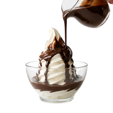 Hot fudge pouring onto vanilla ice cream sundae in a glass bowl filled with chocolate sauce