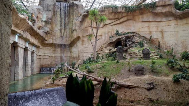 Belgium Pairi Daiza Zoo Tropical Pavilion Wide Landscape View of Waterfall and Stone Statues