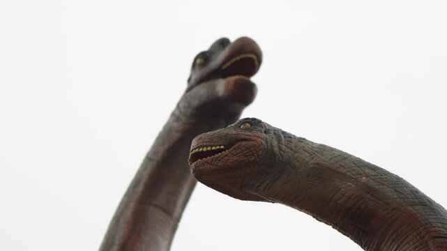 Long-necked dinosaur statues in the prehistoric area of Pairi Daiza Zoo, Belgium.