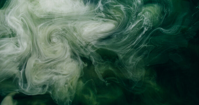 Vapor mix. Watercolor explosion. White green mist spray storm wave ink stream on black abstract background. Glitter blur art texture.