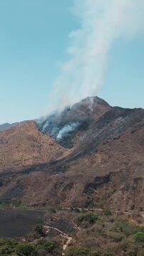 Wildfire smoke rising from a burning mountain in Comala, Colima, Mexico