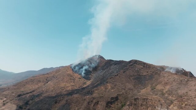 Bushfire releasing thick smoke plumes into the sky over Comala, Colima in Mexico