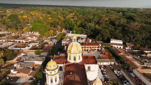 Backward moving aerial view of Parroquia de San Miguel Arc&aacute;ngel in Comala, Colima, Mexico