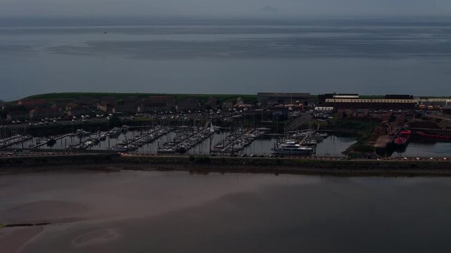 Troon Marina in Ayrshire, Scotland, showing moored yachts, harbour facilities and calm coastal waters at dusk, aerial view