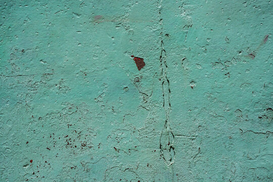 Textura de pared de concreto color turquesa con grietas, desgaste y pintura envejecida