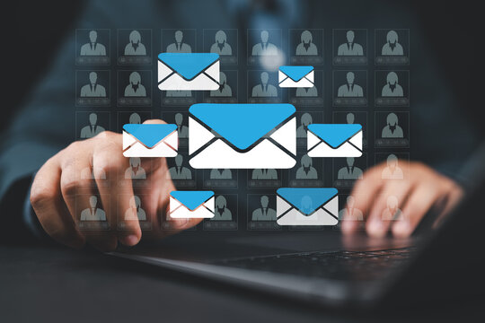 Email marketing automation technology and customer database. Businessman typing on laptop computer keyboard at desk in office.
