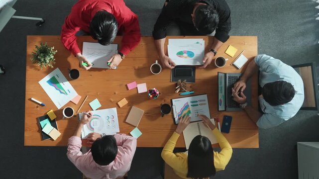 Top view of businesswoman hold tablet display financial graph and place on meeting table with sticky notes. Project manager looking at stock market statistic and analyzing data analysis. Convocation.